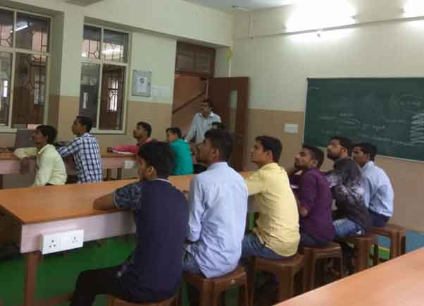 Prof. Suraj Marathe introducing the employees of Godrej and Boyce to PMKVY